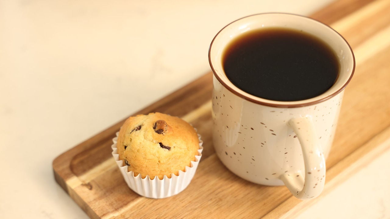 mug of coffee beside a chocolate chip muffin