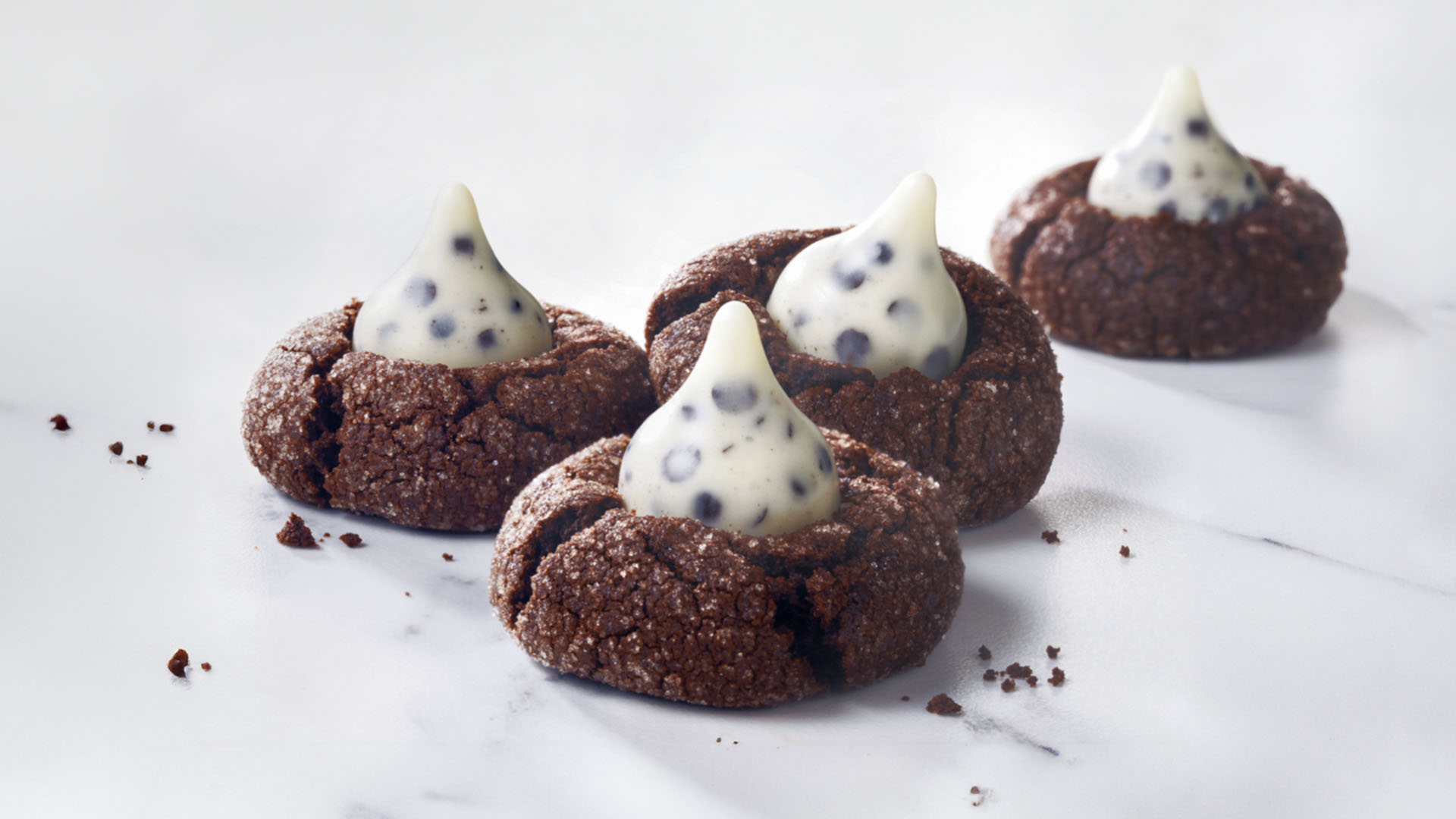 4 cookies n creme chocolate blossom cookies on a marble counter