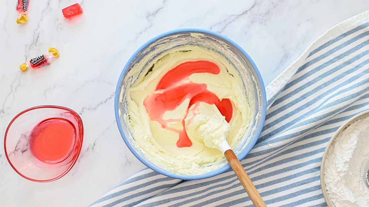 mixing together butter, powdered sugar, and syrup until combined