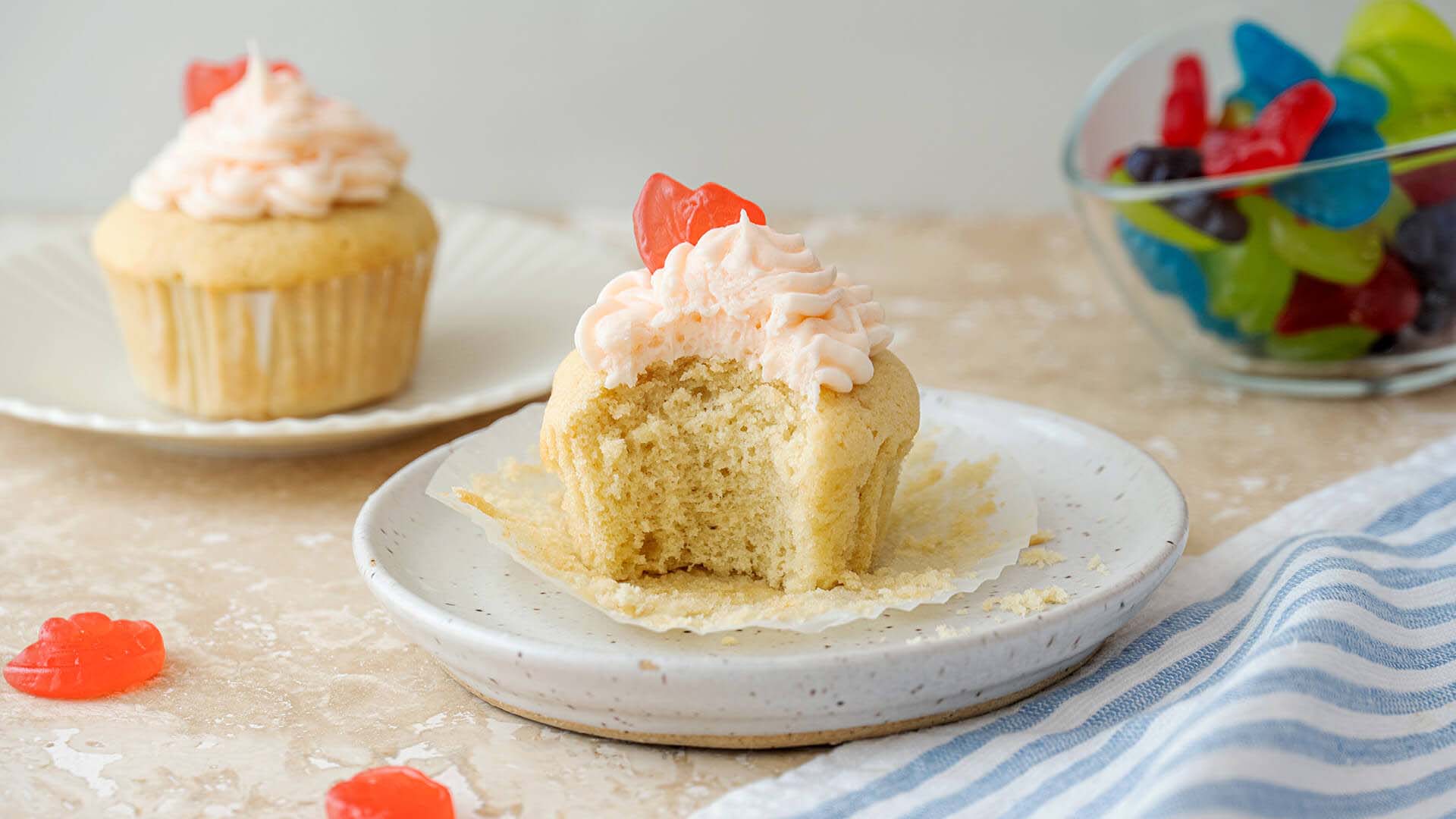 jolly rancher watermelon cupcake plated with a bite taken
