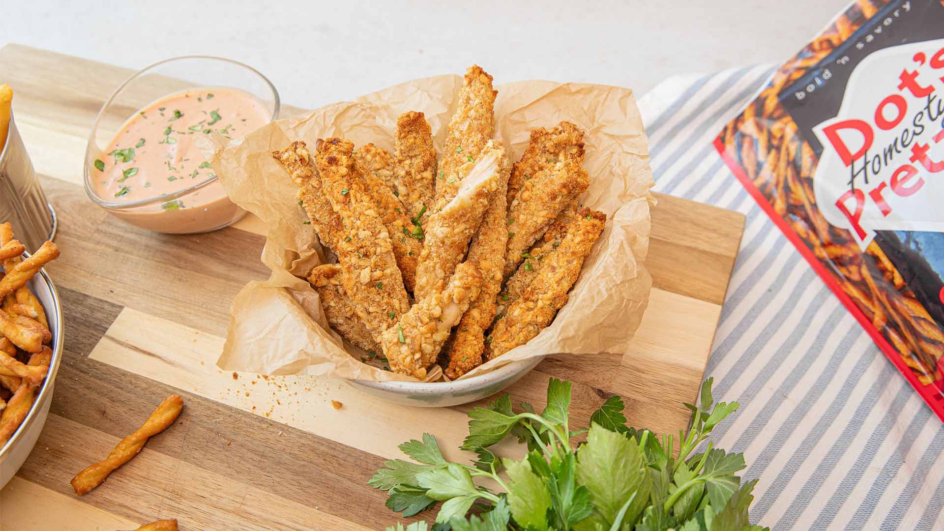 basket of freshly made dots pretzel crusted chicken cut into strips