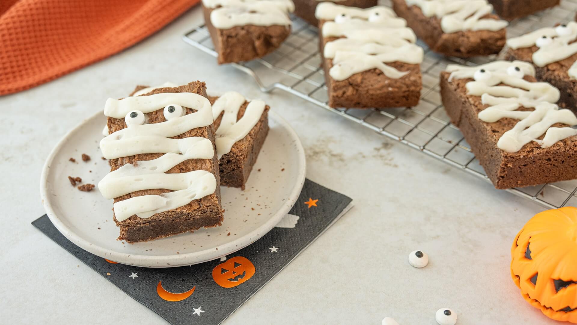 cooling rack of iced mummy brownies