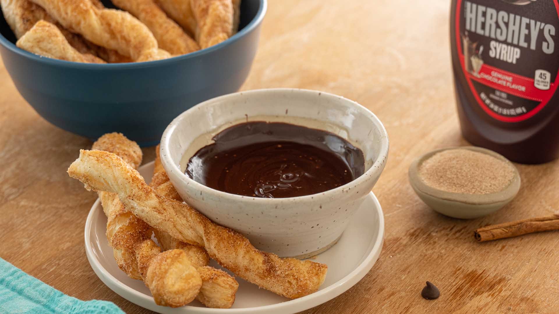 churros next to bowl of chocolate dipping sauce