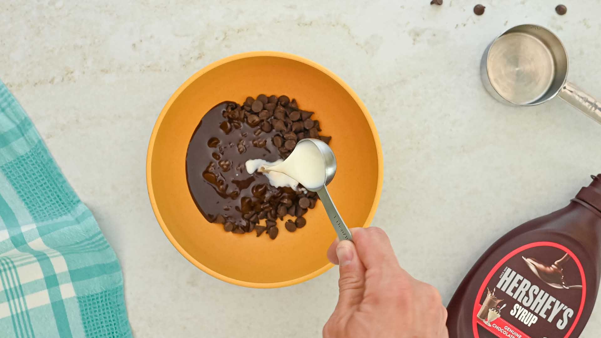 milk added to bowl with chocolate ingredients