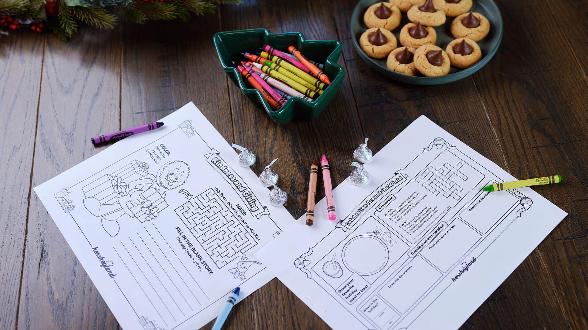 two coloring pages with crayons on table decorated for holiday