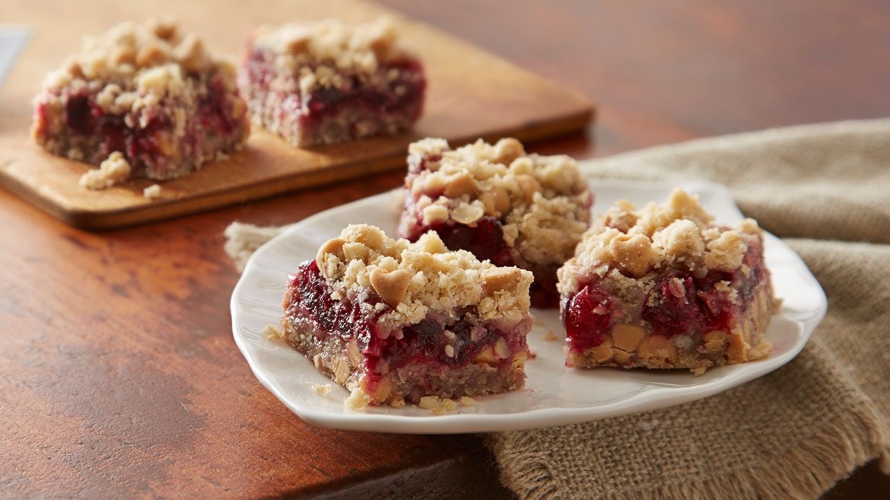 Hersheys Peanutty Cranberry Bars cut into squares on a white plate