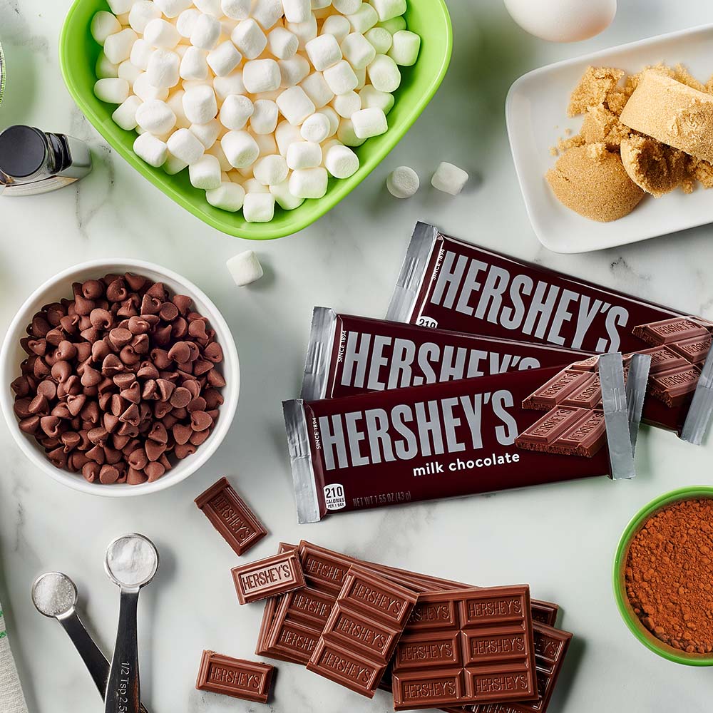 baking ingredients, equipment, and candy spread out on kitchen countertop