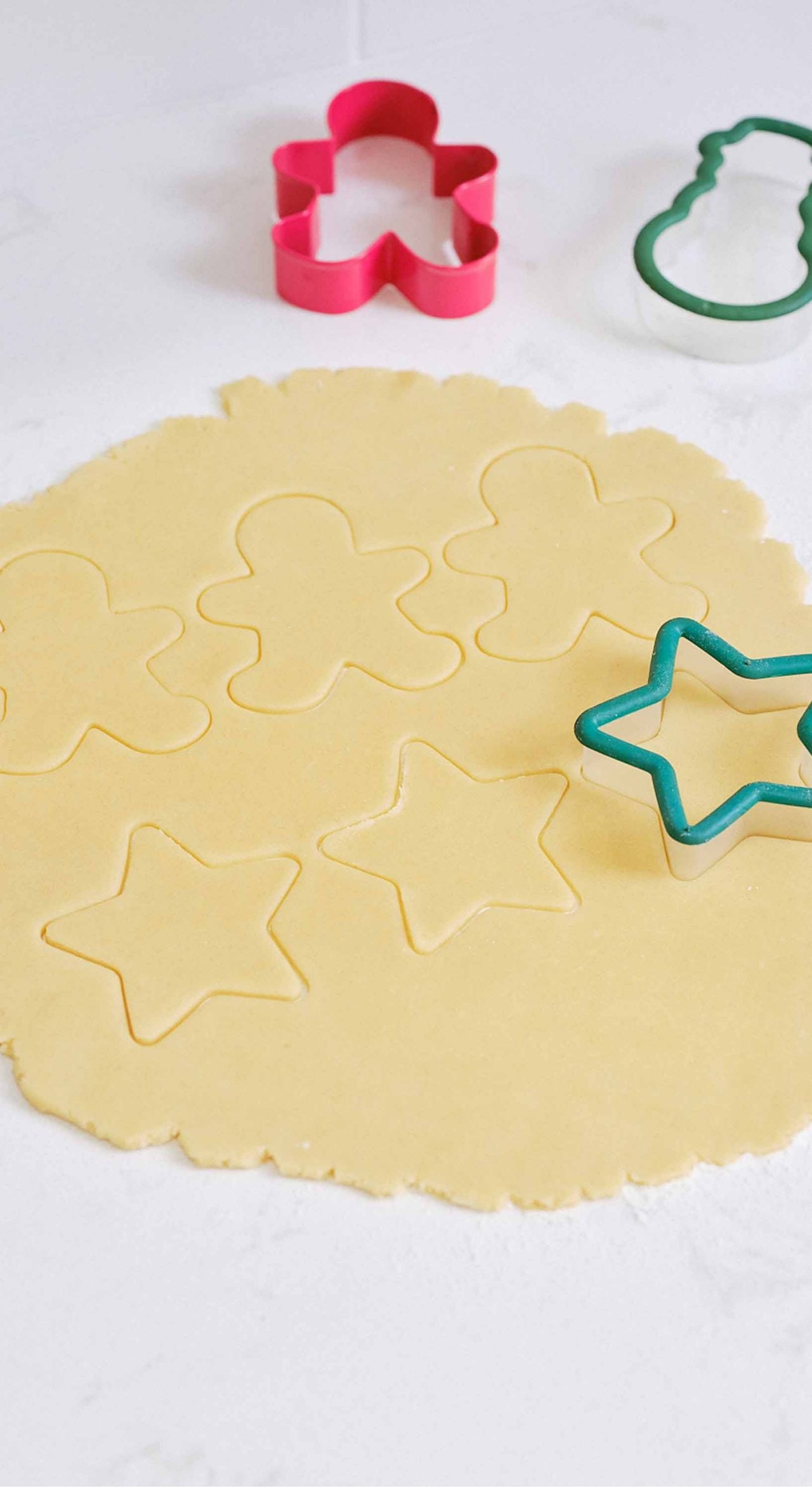 using cookie cutters to create various cookie shapes