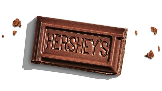 piece of a hersheys milk chocolate bar beside chunks of chocolate