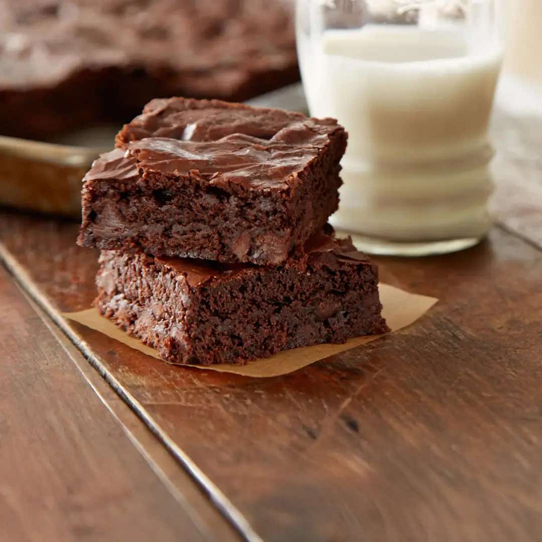 brownie squares nect to glass of milk